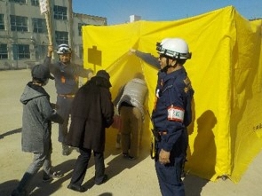 写真:煙道体験を指導する消防団員