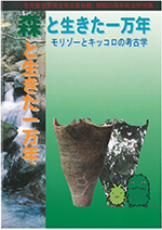 図録の表紙写真です。愛・地球博のキャラクターモリゾーとキッコロが立つ横には、千葉県の二ツ木貝塚で出土した土器の画像が配置されています。縄文時代をほうふつとさせる、谷川の写真も載っています。