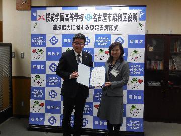 写真:両者代表による記念撮影