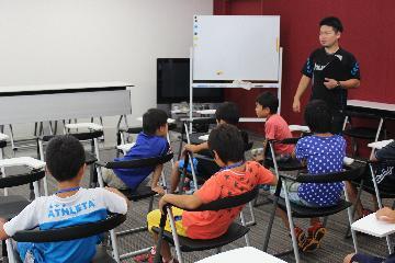 写真：記者会見に使われる部屋の説明を受けている様子