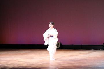 写真:白色の着物の女性が日本舞踊を踊る様子