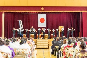 写真：おめでとうのメッセージを掲げる太鼓演奏をした小学生たち