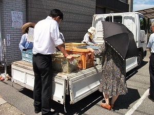 写真：境根朝市で商品を眺めている区長