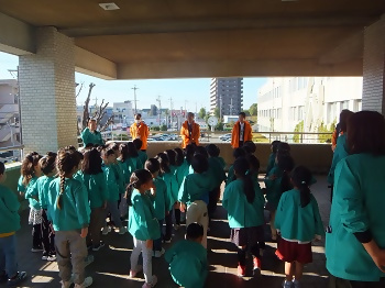 写真：子どもたちを出迎える水野区長（中央）