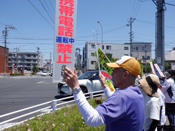 写真：サイン板をもつ区長