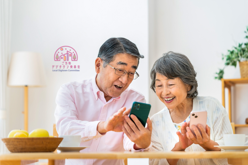 画面を夫婦でのぞいている様子の写真