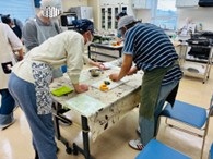 画像:サポートを受けながら調理する参加者の皆さん