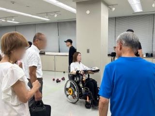参加者に囲まれて談笑する関根さんの写真