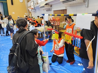 画像:縁日のお楽しみゲームを楽しむ親子の様子