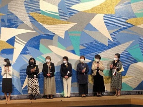 女性会の皆さんが壇上で挨拶をしているところ