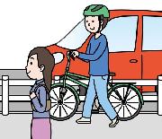 歩道上で自転車を押して歩く画像